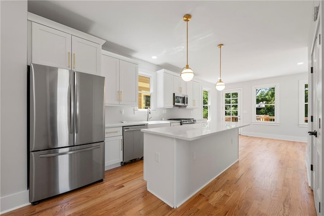 110 Hogue St, Atlanta, GA 30312 - kitchen featuring appliances with stainless steel finishes, light countertops, light wood-style floors, white cabinetry, and recessed lighting