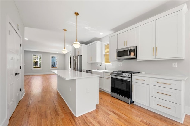 110 Hogue St, Atlanta, GA 30312 - kitchen with appliances with stainless steel finishes, recessed lighting, light wood-style flooring, a center island, and a sink
