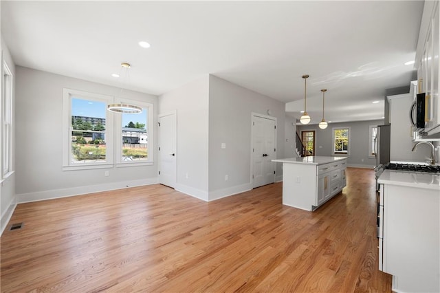 110 Hogue St, Atlanta, GA 30312 - kitchen featuring light wood-style floors, a kitchen island, baseboards, and recessed lighting