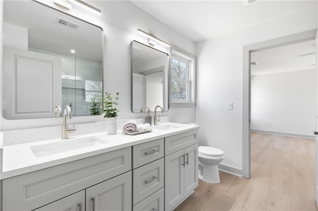 42 Riverdale St, Canton, GA 30114 - bathroom with double vanity, wood finished floors, toilet, and baseboards