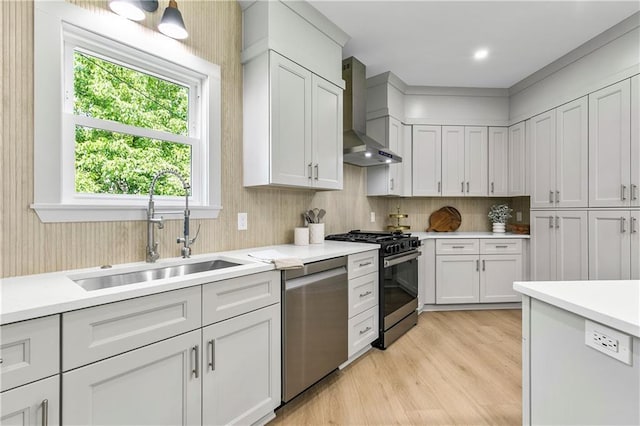 42 Riverdale St, Canton, GA 30114 - kitchen with stainless steel appliances, wall chimney exhaust hood, a sink, a kitchen breakfast bar, and light wood finished floors