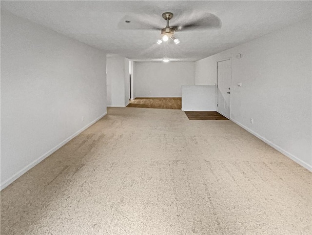 spare room featuring carpet, a textured ceiling, and a wealth of natural light