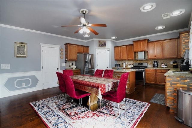 dining area with ceiling fan, visible vents, ornamental molding, and dark wood finished floors