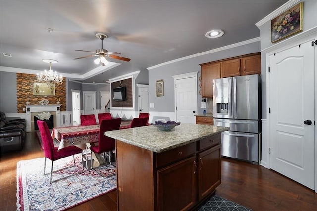 kitchen with dark wood-style flooring, stainless steel refrigerator with ice dispenser, crown molding, and ceiling fan with notable chandelier