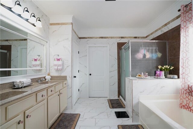bathroom featuring crown molding, a sink, marble finish floor, a shower stall, and a garden tub