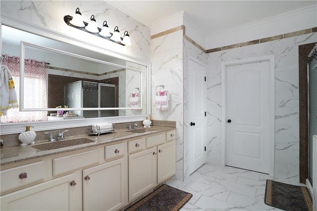full bathroom with double vanity, ornamental molding, a sink, and marble finish floor