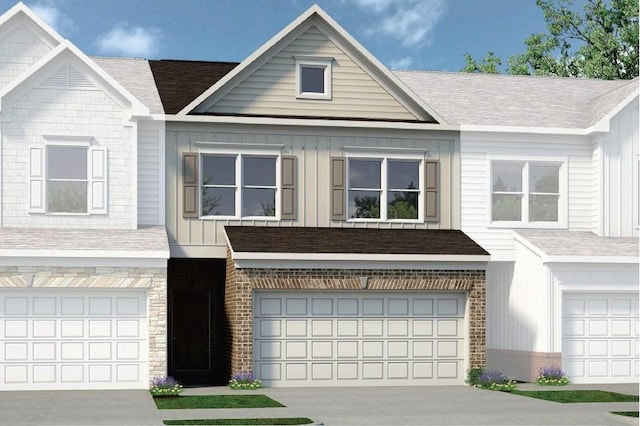 view of front of home with a garage, stone siding, concrete driveway, and board and batten siding