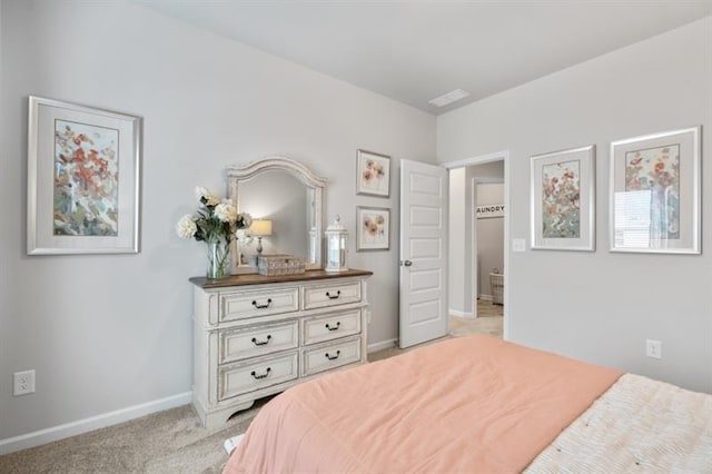 bedroom with baseboards and light carpet