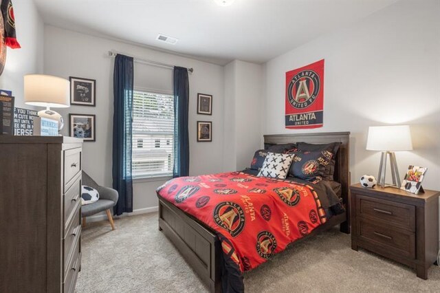 bedroom featuring light carpet and baseboards