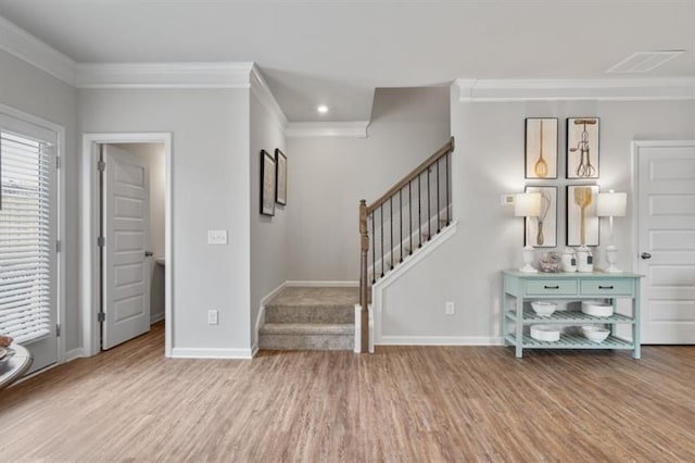 entrance foyer featuring wood finished floors, crown molding, stairway, baseboards, and recessed lighting
