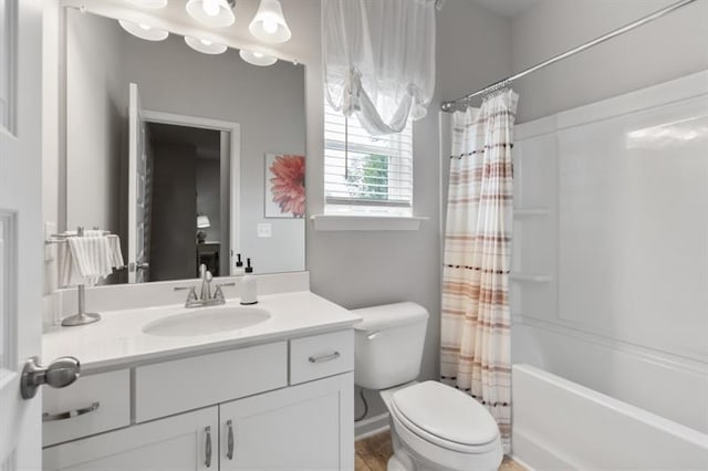 full bathroom featuring toilet, vanity, and shower / bathtub combination with curtain