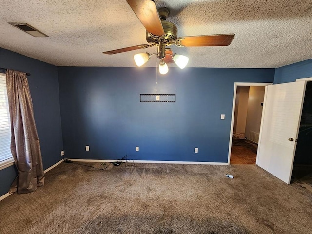 carpeted spare room with a textured ceiling and ceiling fan