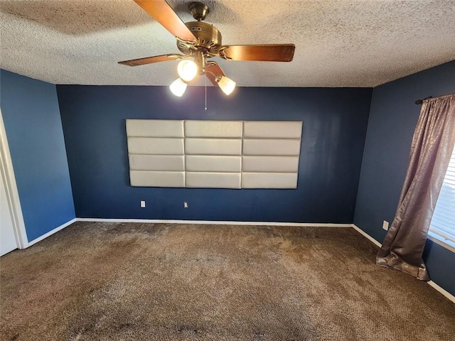 unfurnished room featuring a textured ceiling, ceiling fan, and carpet floors