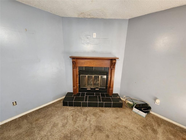 details featuring carpet, baseboards, a textured ceiling, and a tiled fireplace