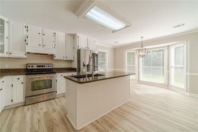 4120 Grady Smith Rd, Loganville, GA 30052 - kitchen with appliances with stainless steel finishes, light wood-type flooring, ornamental molding, decorative backsplash, and white cabinets