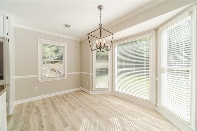 4120 Grady Smith Rd, Loganville, GA 30052 - unfurnished dining area featuring a chandelier, crown molding, and light wood-style flooring