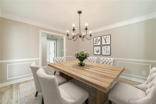 4120 Grady Smith Rd, Loganville, GA 30052 - dining area with a chandelier, light wood-style flooring, and crown molding