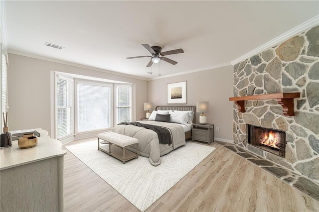 4120 Grady Smith Rd, Loganville, GA 30052 - bedroom with ornamental molding, light wood finished floors, a stone fireplace, and a ceiling fan