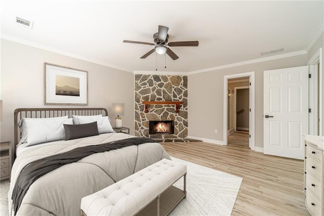 4120 Grady Smith Rd, Loganville, GA 30052 - bedroom featuring crown molding, light wood-type flooring, a fireplace, and ceiling fan