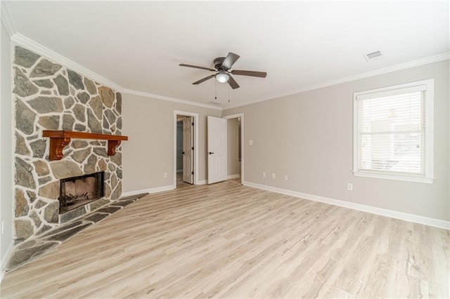 4120 Grady Smith Rd, Loganville, GA 30052 - unfurnished living room featuring light wood finished floors, ceiling fan, a stone fireplace, and ornamental molding