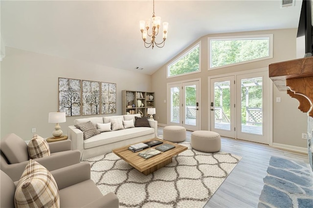 4120 Grady Smith Rd, Loganville, GA 30052 - living area with a chandelier, wood finished floors, and high vaulted ceiling