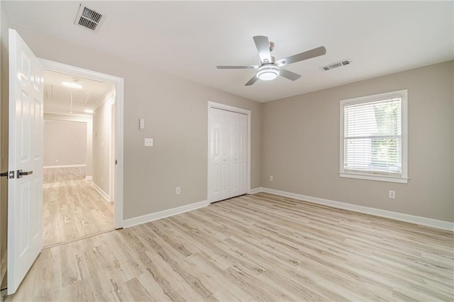 4120 Grady Smith Rd, Loganville, GA 30052 - unfurnished bedroom with attic access, light wood finished floors, a closet, and a ceiling fan