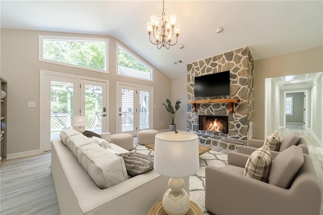 4120 Grady Smith Rd, Loganville, GA 30052 - living area featuring a chandelier, light wood finished floors, a stone fireplace, and lofted ceiling