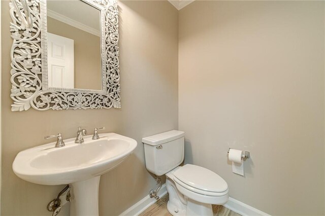 4120 Grady Smith Rd, Loganville, GA 30052 - half bathroom featuring crown molding and wood finished floors