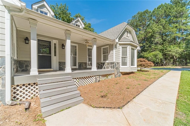 4120 Grady Smith Rd, Loganville, GA 30052 - doorway to property featuring covered porch, a ceiling fan, and stone siding