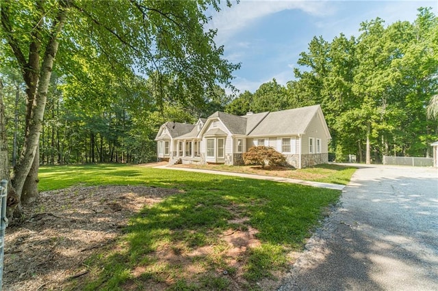 4120 Grady Smith Rd, Loganville, GA 30052 - view of front of property with stone siding, a front yard, and driveway