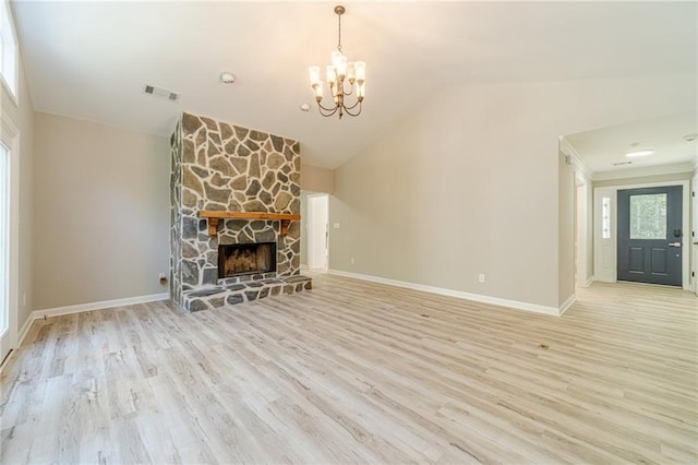 4120 Grady Smith Rd, Loganville, GA 30052 - unfurnished living room with a chandelier, lofted ceiling, light wood-style flooring, and a fireplace