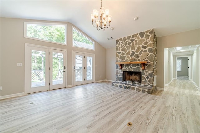 4120 Grady Smith Rd, Loganville, GA 30052 - unfurnished living room with a chandelier, wood finished floors, a fireplace, and high vaulted ceiling