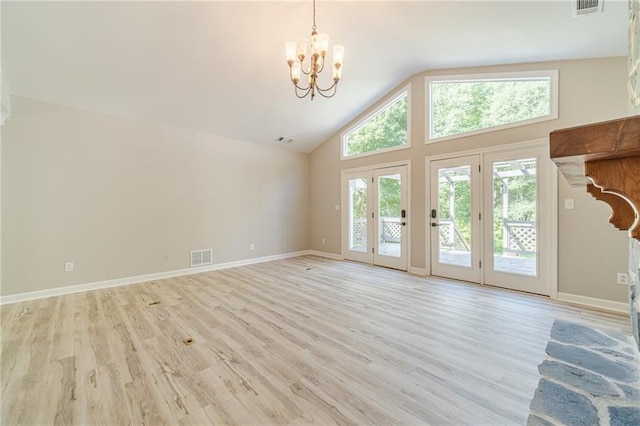 4120 Grady Smith Rd, Loganville, GA 30052 - unfurnished living room with a chandelier, light wood finished floors, and high vaulted ceiling