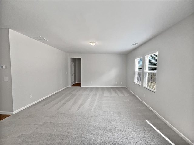 spare room featuring light colored carpet