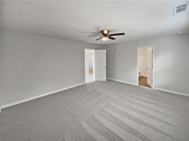 carpeted spare room with ceiling fan