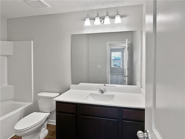 full bathroom featuring shower / bathing tub combination, vanity, and toilet