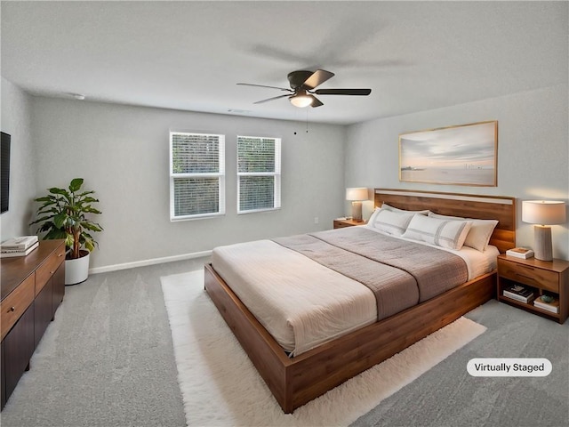 bedroom featuring light colored carpet and ceiling fan