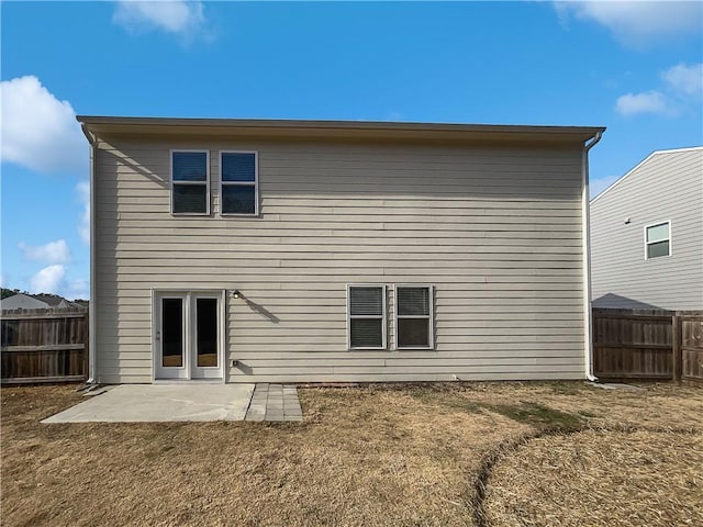 rear view of house with a lawn and a patio area