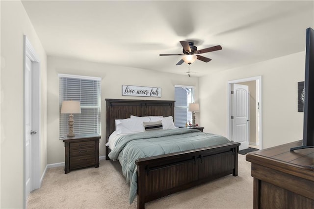 bedroom featuring light carpet, baseboards, and a ceiling fan
