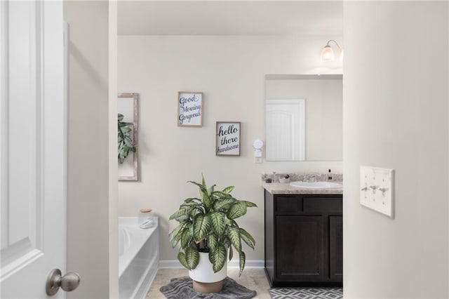 bathroom with a bath, baseboards, tile patterned flooring, and vanity