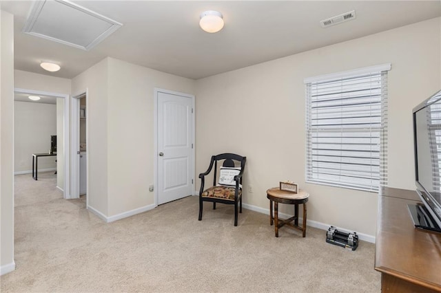 sitting room with baseboards, carpet, attic access, and visible vents