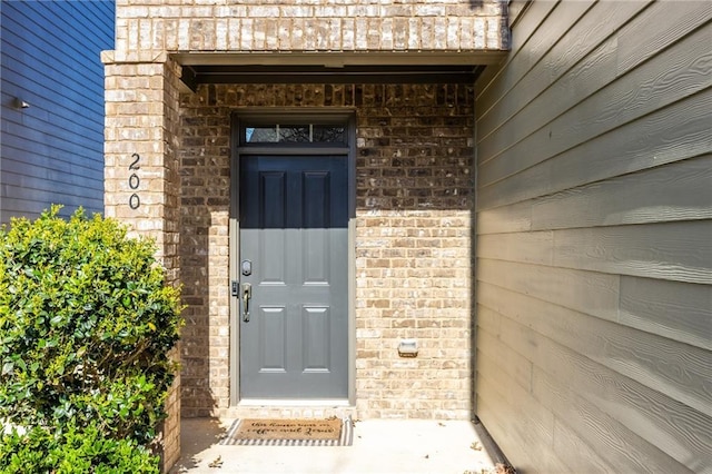 entrance to property with brick siding