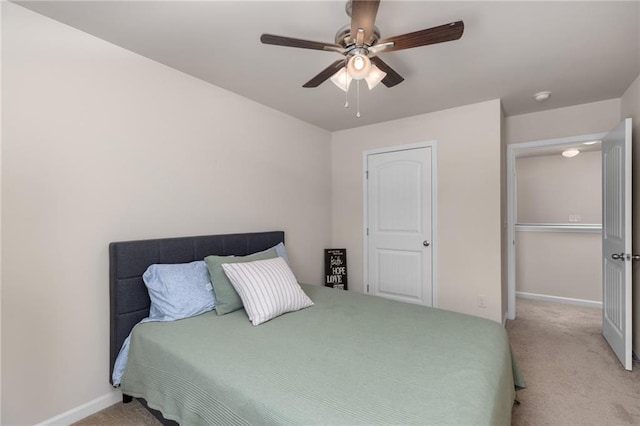 bedroom with baseboards, carpet flooring, and a ceiling fan