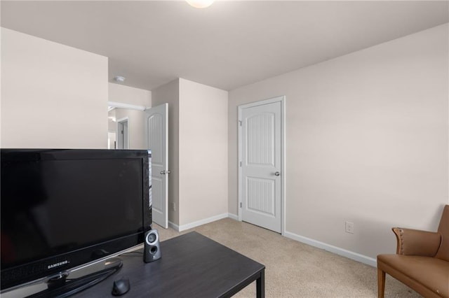 office space featuring baseboards and light carpet