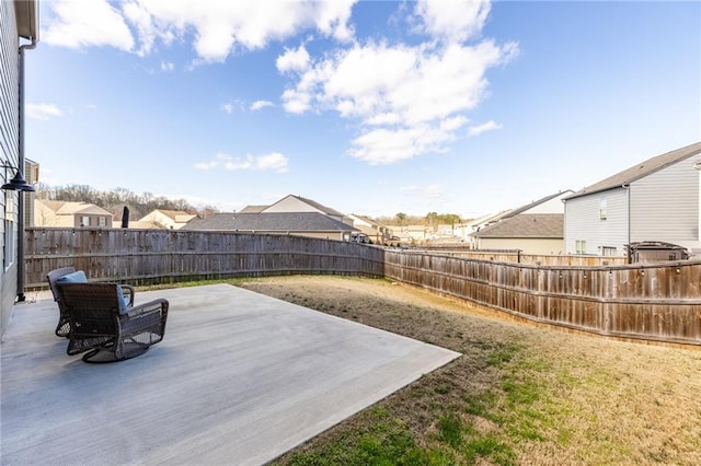 view of yard with a residential view, a fenced backyard, and a patio area
