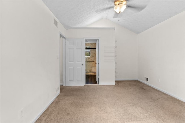 2568 Redfield Dr, Norcross, GA 30071 - unfurnished bedroom featuring carpet floors, vaulted ceiling, a textured ceiling, baseboards, and ensuite bathroom