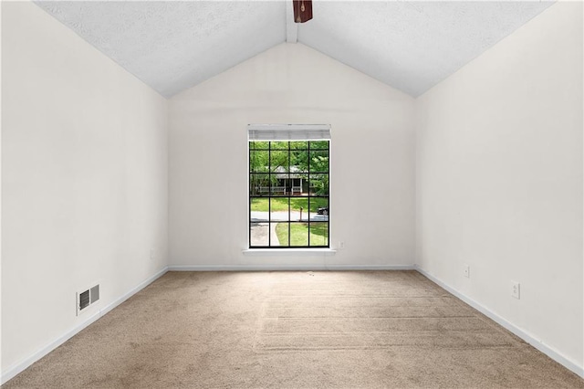 2568 Redfield Dr, Norcross, GA 30071 - carpeted empty room with vaulted ceiling, baseboards, and a textured ceiling