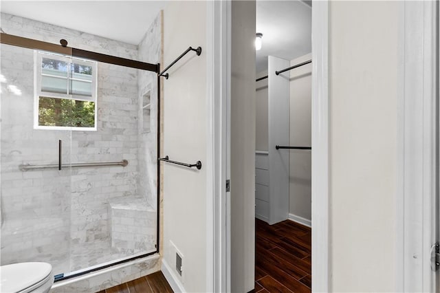 2568 Redfield Dr, Norcross, GA 30071 - full bathroom with a stall shower, wood finished floors, toilet, and baseboards