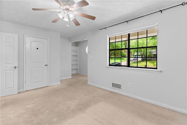 2568 Redfield Dr, Norcross, GA 30071 - unfurnished bedroom featuring carpet, baseboards, a textured ceiling, and ceiling fan