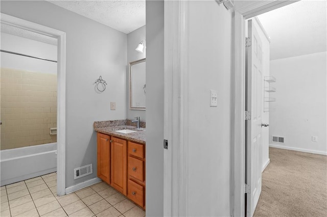 2568 Redfield Dr, Norcross, GA 30071 - full bathroom with vanity, baseboards, tile patterned flooring, shower / bathtub combination, and a textured ceiling